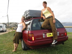 Two girls standing by a used car for sale in Sydney