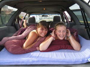 Two girls in the bed in the back of Travelwheels Cheap Car hire Sydney special