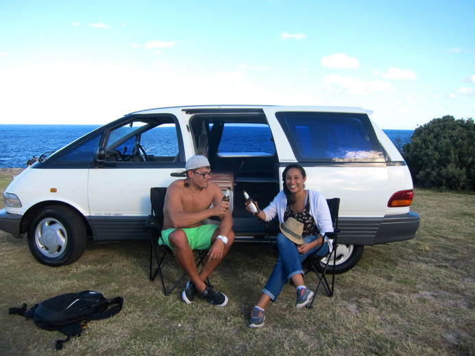 Two people enjoying a beer with Sydney Camper van Hire 