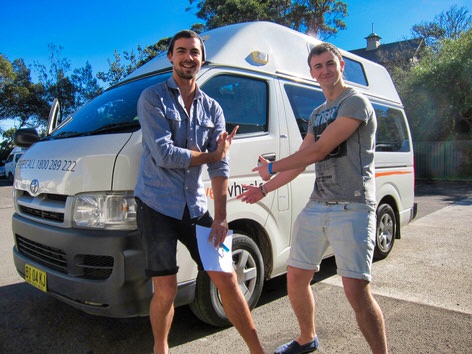 Two customers standing by a campervan in Sydney 