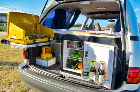 Kitchen inside a Toyota Tarago Automatic camper with fridge, cooker and sink