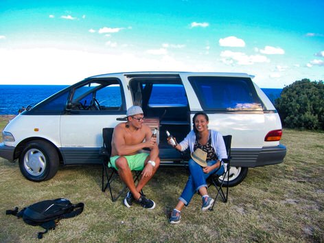 2 person campervan hire - two travellers enjoying a beer outside the campervan - cheers!