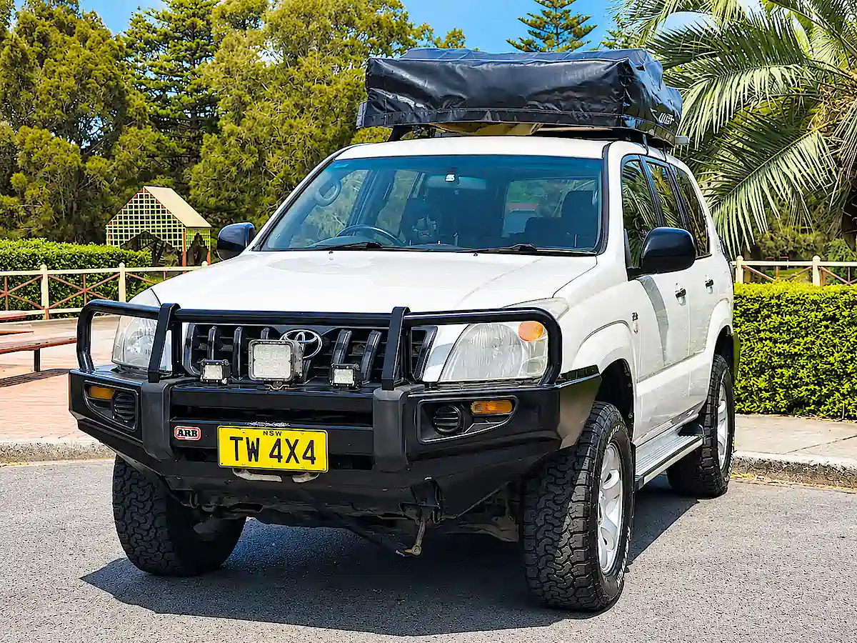 Used Toyota Prado for sale with roof tent - front passenger side view