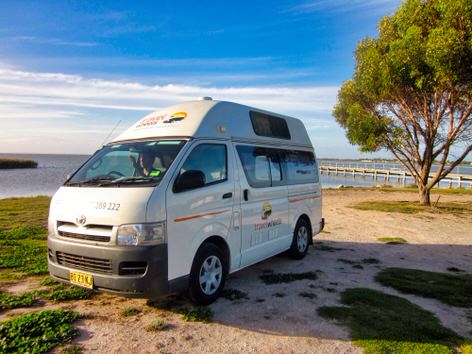 Toyota Hiace Campervans for sale Sydney parked next to a beach