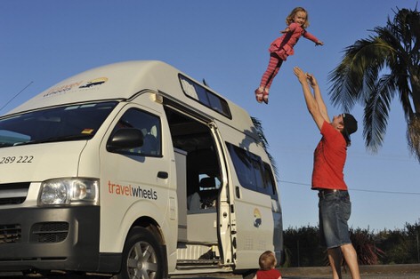 Family playing with kids outside their family friendly Toyota automatic campervan for sale