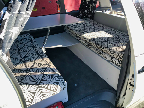 Table and benches inside Toyota campervan