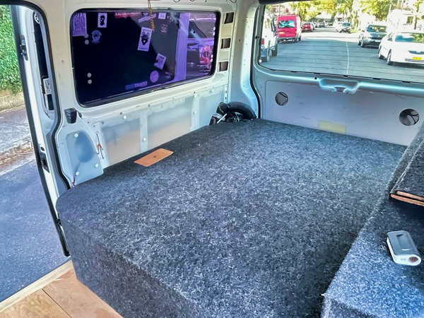 Used VW Campervan for sale in Sydney - Automatic Model in white - photo showing the size of the rear sleeping area and has underfloor carpet to keep the vehicle clean