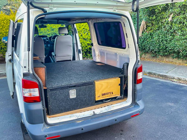 Used VW Campervan for sale in Sydney - Automatic Model in white - photo showing the rear sleeping area and underfloor storage