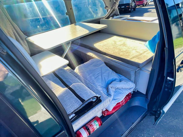 used toyota tarago campervans for sale - Automatic Model - photo showing the inside of the campervan with two comfortable benches and a removable table in the photo