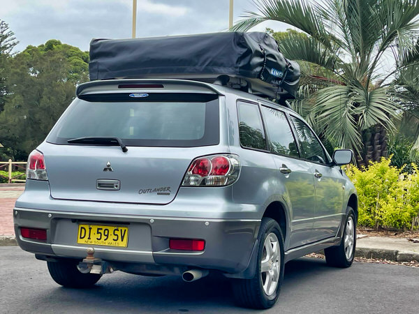 Roof Top Tent 4x4 for sale in Sydney - Model shown is a Automatic Mitsubishi Outlander with roof top tent - photo showing the rear driver side angle view with roof tent closed