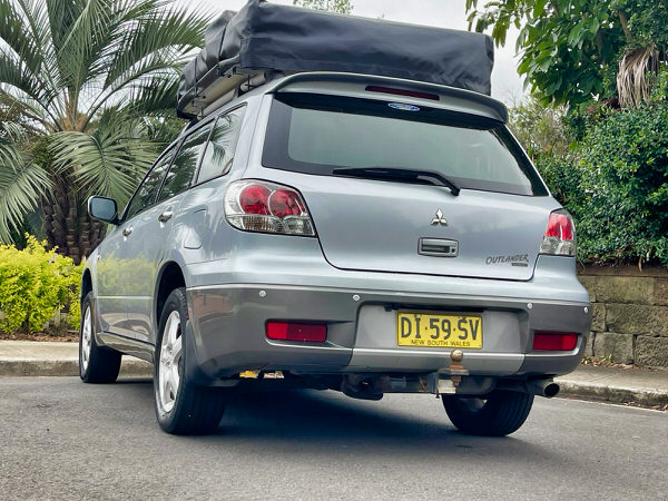 Roof Top Tent 4x4 for sale in Sydney - Model shown is a Automatic Mitsubishi Outlander with roof top tent - photo showing the rear passenger side angle view with roof tent closed
