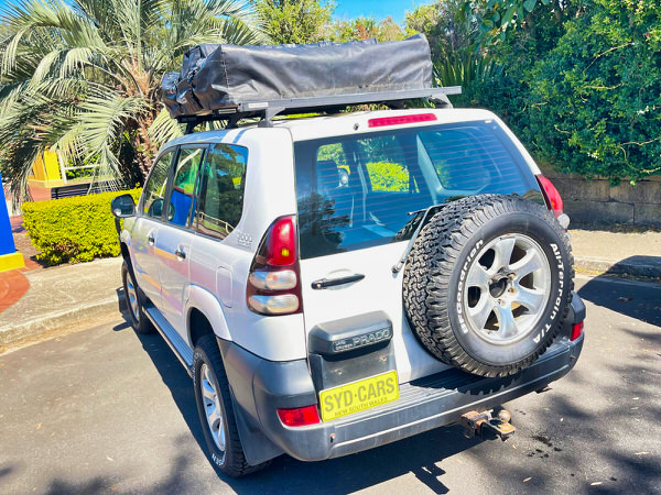 Used Toyota Prado for Sale - Manual 2008 Turbo Diesel Model with heavy duty Roo bars and roof rack + Roof Top Tent - photo showing the rear angle view with roobars and the roof top tent folded away 