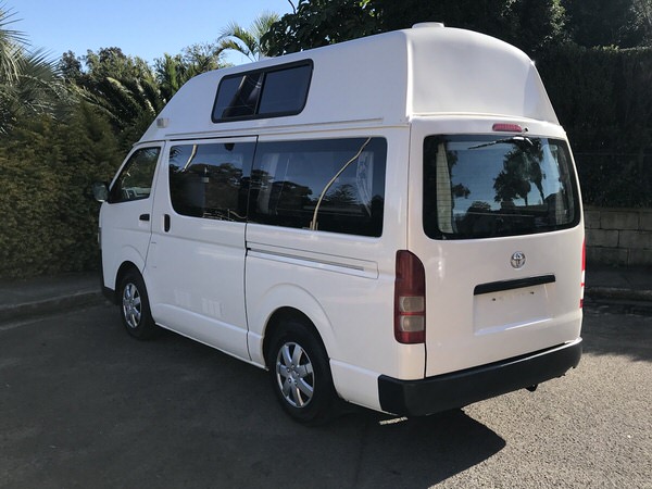 Camper kaufen Australien mit Travelwheels Autoverkauf in Sydney - photo showing the rear passenger side angle view of a Toyota Hiace 3 Person campervan for sale