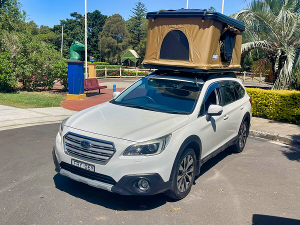 Roof Top Tent Camper for Sale in Sydney – Model shown is a Subaru Outback Automatic Station Wagon AWD with Roof Top Tent - photo shows the front passenger side angle view with the roof top tent open to get a good night sleep