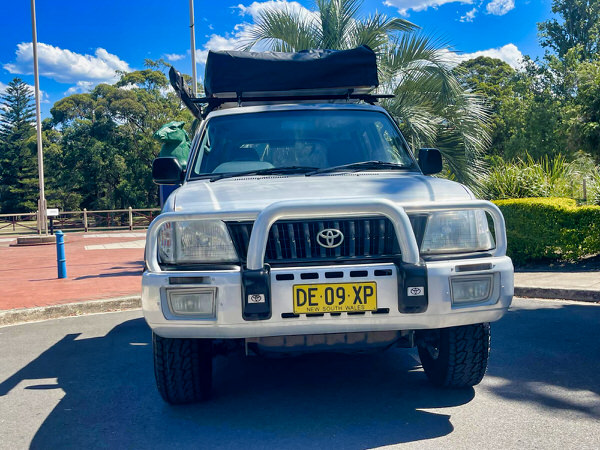 Toyota Prado for sale - model shown in the image is a Toyota Prado with Roof Tent + Side Awning + Bullbars - photo showing the front straight on view