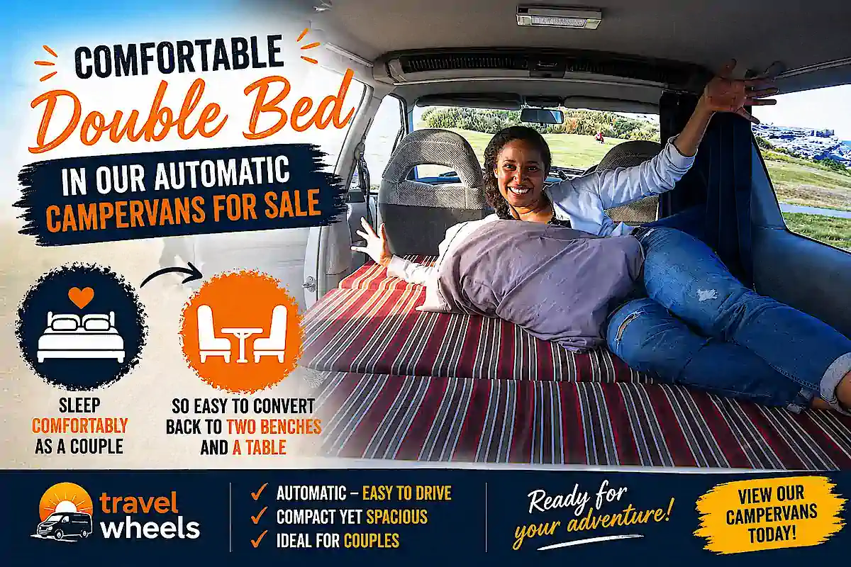 Double bed inside this Toyota campervan for sale - young woman showing the size of the bed