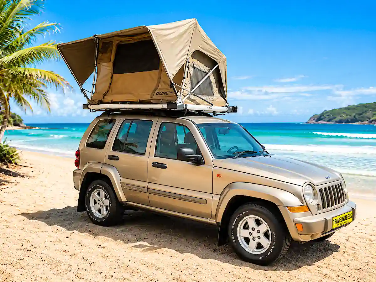 Used Jeep for sale with roof top tent open at the beach ready to travel