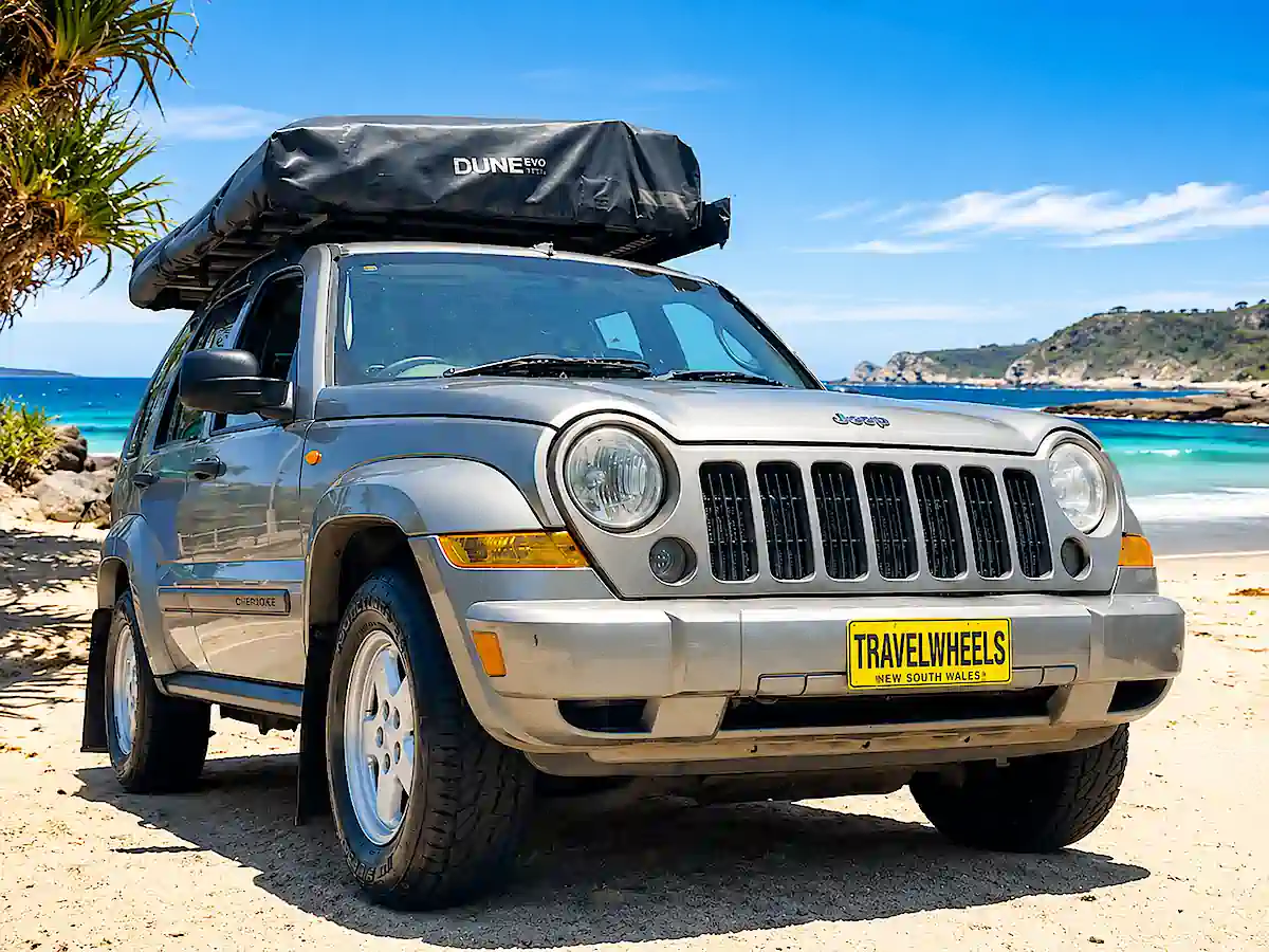 Used Jeep for sale - front driver side view with rooftop tent closed