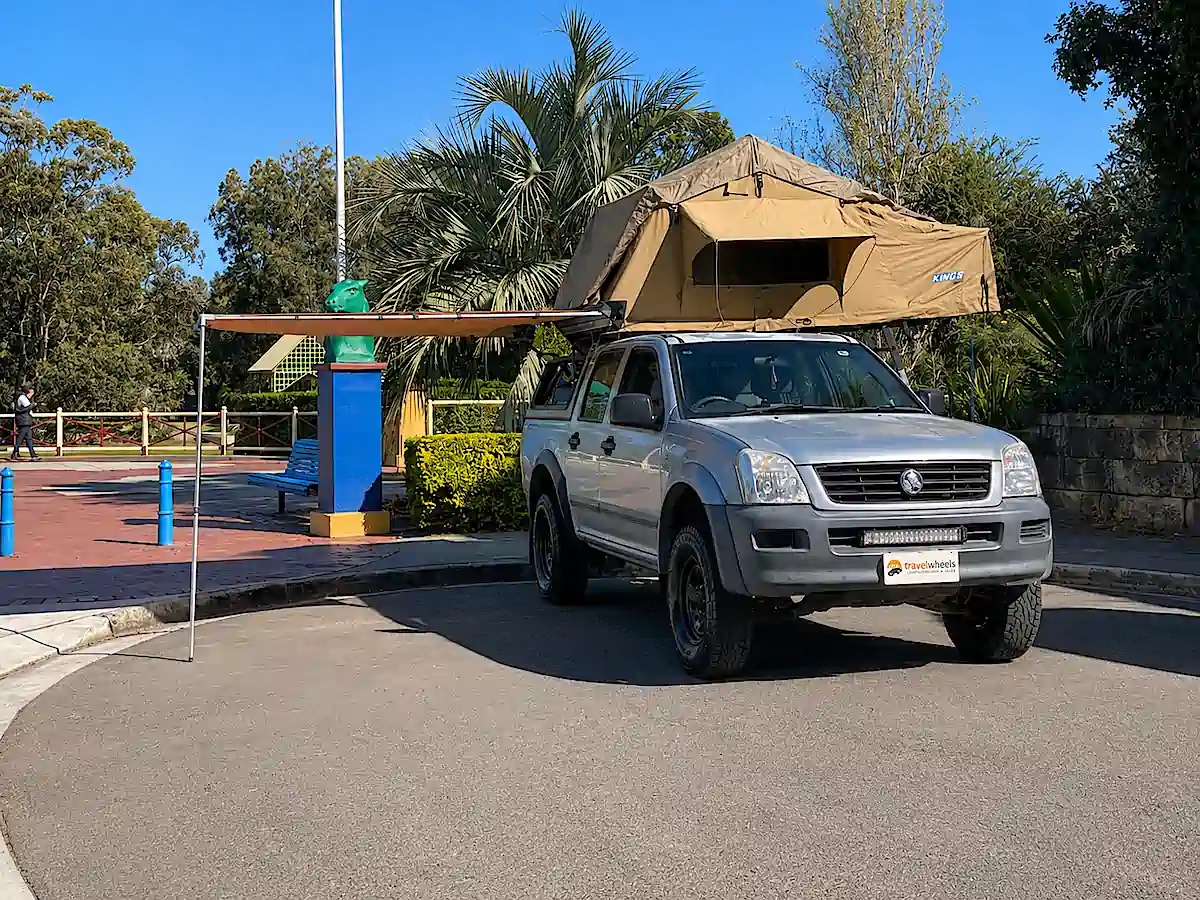 Roof Top Tent Camper for sale at Travelwheels Campervans - photo of front driver side with awning and roof tent open