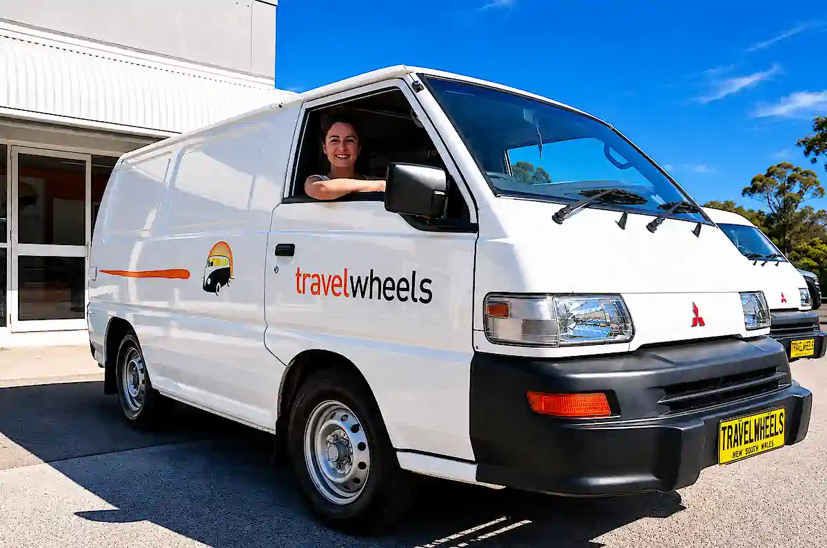 budget campervan for sale - woman driving away after buying campervan from Travelwheels