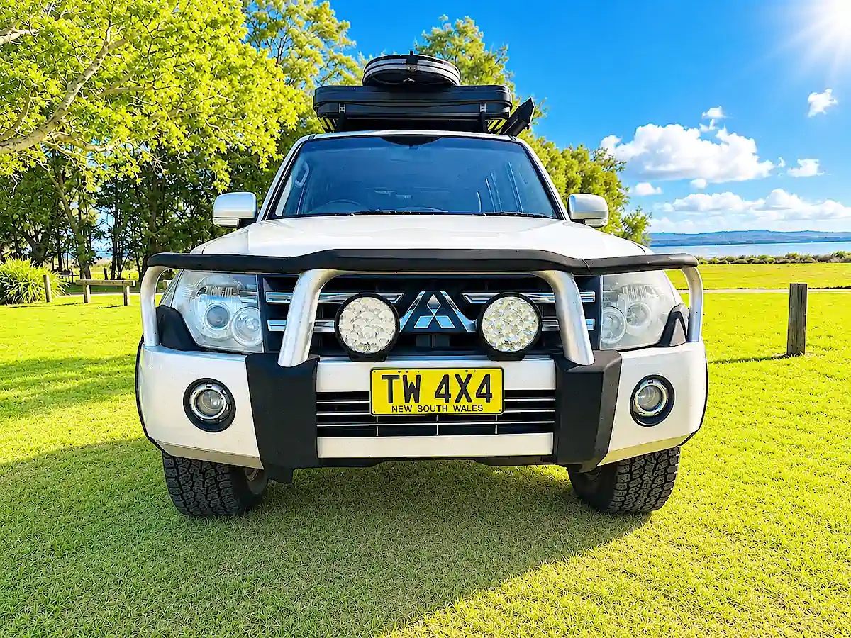 Mitsubishi Pajero for sale with Roof tent - front straight on view with bull bars and headlamps
